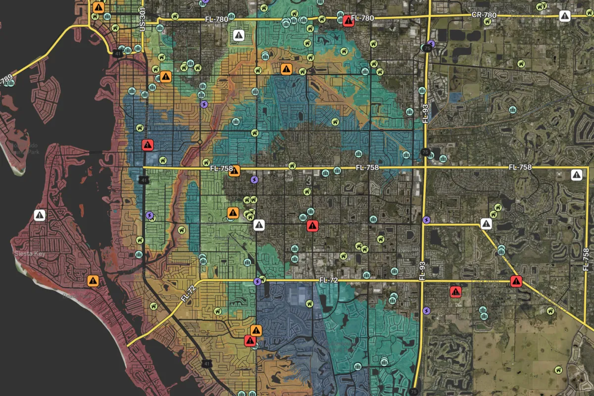 A digital GIS hazard map of a coastal city showing color-coded flood zones and emergency alert icons, used by government agencies to coordinate disaster response and manage infrastructure safety.