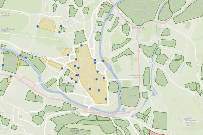 A Felt map of central Bath with liveable neighborhood areas outlined in yellow and blue photo pins